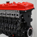 complete engine block with orange rocker cover with white background with logo