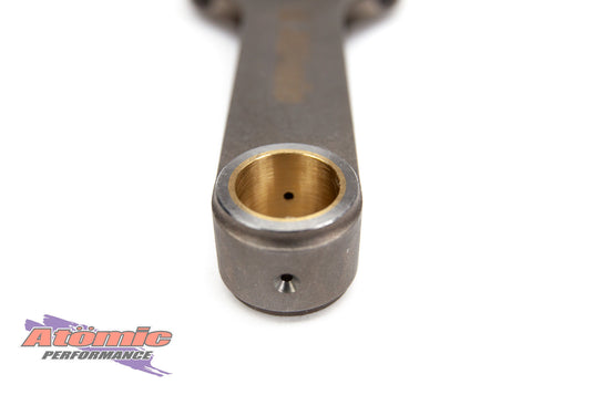 Metal connecting rod with brass bushing on a white background, featuring Atomic Performance logo.