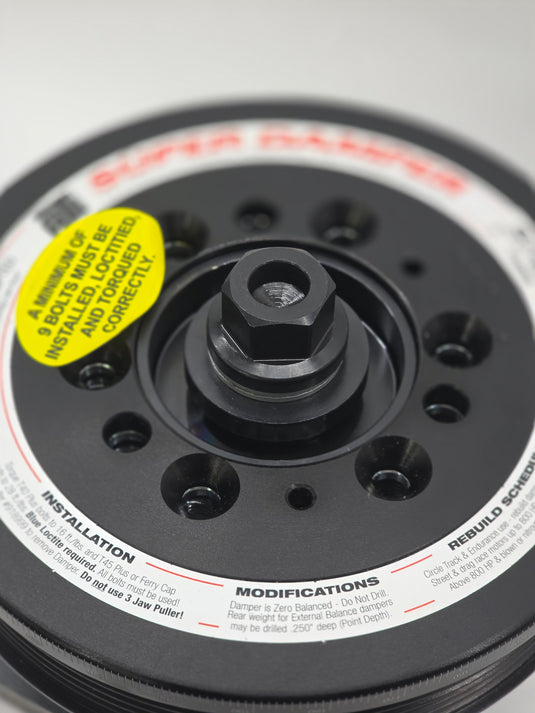 black ati balancer with labelling with black bolt on white background