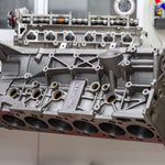 Engine block on a stand in a workshop setting