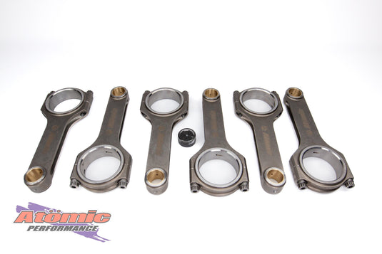 Set of connecting rods on a white background with Atomic Performance logo.