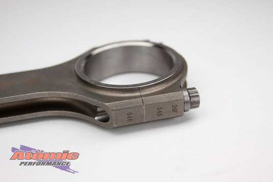 Metal connecting rod with atomic performance products branding on a white background