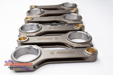 Set of metallic connecting rods with 'Atomic' branding on a white background