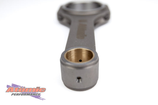 Metal connecting rod with 'Atomic Performance' branding on a white background