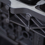 close-up of cast engine block on a black surface