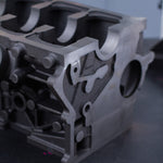 cast engine block on black surface with dark background