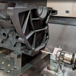 machining of cast engine block with steel background