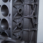 gray upright cast engine block with white background