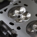 close up of engine cylinder head with stainless steel valves 