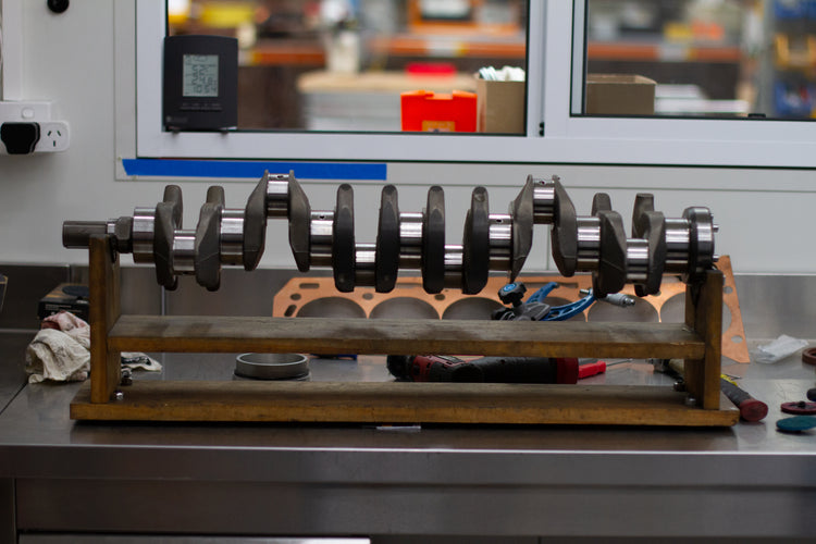 engine crank on a wooden stand 