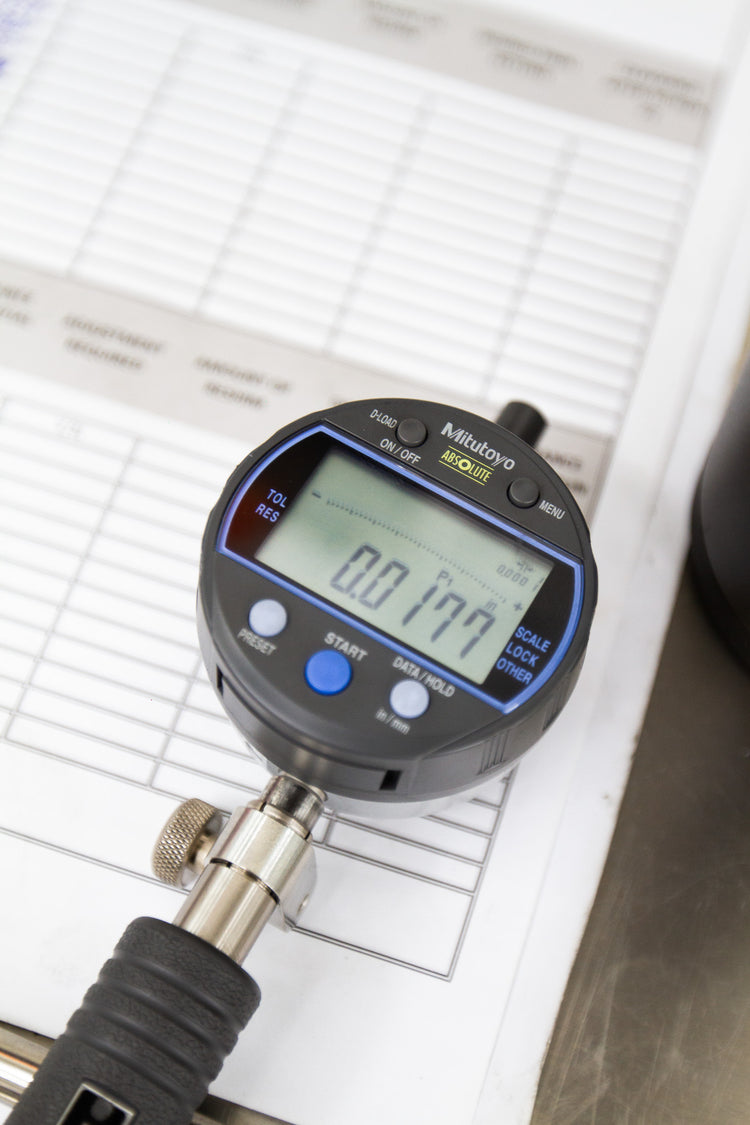 digital dial indicator with measurements with engine sheet in background
