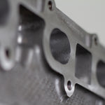 engine cylinder head exhaust port zoomed in with white background