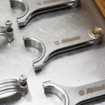 metal connecting rods on a steel/silver background