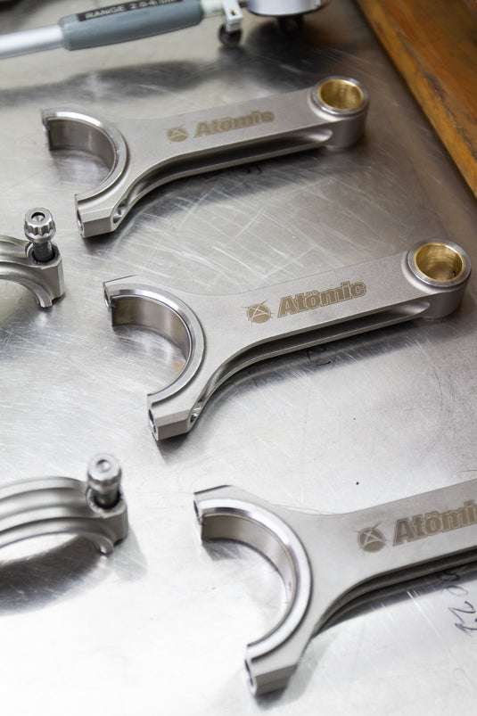 metal connecting rods on a steel/silver background