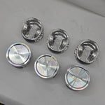 close up of top and underside of  cast engine piston heads on white background 