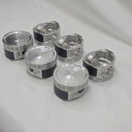 close up of top and underside of  cast engine piston head on white background 