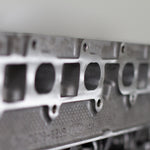 engine cylinder head exhaust port with engine numbers with a white background